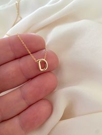 **Each piece in my shop, I personally create and photograph. (All photos are property of The Cord Gallery LLC) Thank you for supporting my small business. Tiny Gold Initial Necklace -  Gold Filled Now all Gold Filled - Waterproof!! Add a personal touch to your accessories collection with this Dainty Gold Initial Necklace!  Features a 18k Gold Filled Mini Initial Letter. Each letter is 3D for added interest and texture and hangs seamlessly on your choice of Gold Filled Link or Gold Filled Box cha