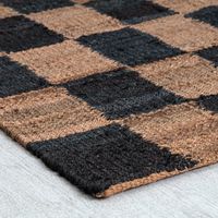 Roll out a rustic, homey feel in your space with this area rug. It shows off a checkered pattern of natural brown and neutral hues, making it easy to pair with colorful and neutral decor. It shows off a woven texture that adds a cozy feel underfoot. Hand-loomed from jute, this rug has a low 0.25'' pile that's ideal for high-traffic spaces, where it won't interfere with your doorway or your vacuum. Plus, it's safe to place on heated floors. We recommend adding a rug pad underneath to keep it from