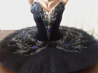 New Collection 2019! An extreme original, Russian, Black Swan costume, just created by Giselle Tutu's team of professional designers. This tutu is created using black velvet for the bodice, silver for the trims, and blue/grey sequin appliques to decorate the whole top of the bodice. The professional, 10 layers tutu platter is pleated, and embellished like the bodice. Ruffled panties, double row of hooks and eyes in the bodice, plus string to adjust chest size. This tutu is just astonishing under