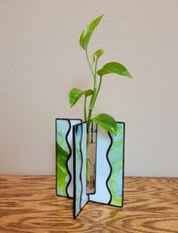 Stained glass bud vase or can be used for plant propagation.  Green, pale blue or light blue with white glass.  Size - 6" h x 5.25" w.  Glass vial included.   Plant not included.  Free shipping.