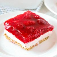 Raspberry jello pretzel salad is a little sweet, a little salty and a LOT of deliciousness! The cream cheese mixture and salted pretzel crust mixed with the raspberry jello is the absolute perfect combination.