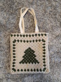 This is a hand crocheted bag that I designed with a Christmas tree on it. It is very useful for everyday use and is fun and aesthetic.