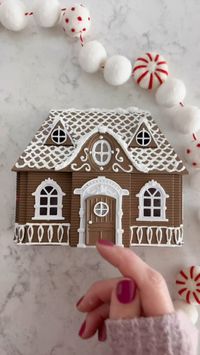 ✨Make a Gingerbread House with me!✨ ❄️Comment “link” for supplies❄️Save & Share this Christmas craft! I found this little plastic dollhouse at Dollar Tree but a paper mache or wooden craft one would be a cute DIY, too! First pop the windows and door off since they’re already white , spray paint the house and door brown. Once it’s dry, use puffy paint to draw on details; I followed the lines that were already on the dollhouse. I dry brushed a few areas just to give it a snowy haze look (the sid