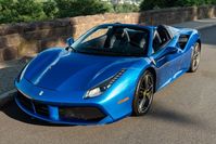 This 2019 Ferrari 488 Spider is powered by a twin-turbocharged 3.9-liter V8 paired with a seven-speed F1 dual-clutch automatic transaxle and is finished in Blu Corsa over Blue Sterling leather upholstery. Equipment includes carbon-fiber exterior and interior accents, 20" five-spoke alloy wheels, ceramic-composite brakes, an SCM-E magnetorheological damping system, a retractable hardtop, Scuderia Ferrari fender shields, adaptive front lighting, a suspension lift system, parking sensors, a back...