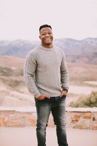 Yarrel is wearing a grey sweater and jeans which is a great outfit during the winter for their engagement photos.