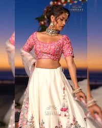 The state of art lehenga features quintessential hand embroidery with intricate floral details, articulated with Resham and metallic threads over sheer pink blouse and a subtle white lehenga. From the classy collection of "𝒯𝒽𝑒 𝓌𝑒𝒹𝒹𝒾𝓃𝑔 𝓈𝓉𝑜𝓇𝓎 𝟤" by "𝒮𝒽𝒾𝓋𝒶𝓁𝒾 𝐹𝒶𝓈𝒽𝒾𝑜𝓃" - "𝒲𝑒𝒹𝒹𝒾𝓃𝑔" . . . . #ShivaliFashion #ShivaliAhmedabad #Shivalifashionahmedabad#exclusivecouture #MadeInIndia #ethnicfashion#ladies #indianwedding #indiandesigners#lehenga #theweddingstory2byShivali