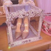 Blinged out glass box in the middle of the cake filled with butterfly's