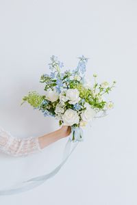 Dusty blue bridal bouquet with roses, oxypetalum and delphinium