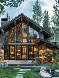 This image features a stunning rustic home exterior with a modern rustic blend, highlighted by its large glass windows that offer a beautiful view. Explore more rustic home exterior ideas on our page.