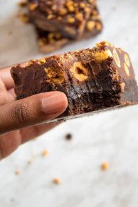 These Ferrero Rocher Fudge Brownies are the ultimate dessert bars! A Ferrero Rocher stuffed fudge brownie, topped with a creamy Nutella Fudge filled and topped with Ferrero Rochers and roasted hazelnuts. Take these bars to another level with a drizzle of silky Nutella Ganache and you’ve got the greatest brownie ever!