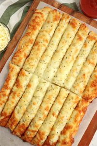 Homemade Cheese Sticks - Delicious garlic pizza crust breadsticks brushed in buttery garlic and layered with cheese. Melty, bubbly, cheesy perfection!