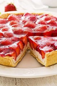 Recipe including course(s): Dessert; and ingredients: almond extract, corn starch, cream cheese, heavy cream, lemon juice, pie crust, powdered sugar, strawberries, sugar, syrup, vanilla extract, water