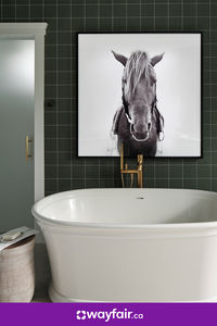 A freestanding white tub, dark green wall tiles, and black-and-white wall art. We're declaring this space our official bathroom goals.

Photos © 2023 Warner Bros. Discovery, Inc. or its subsidiaries and affiliates. All rights reserved.