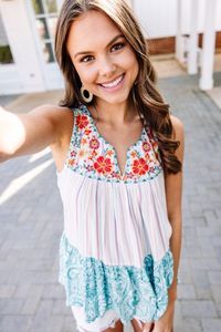 This tank has multiple fun prints within a classic colorblock! Plus, that vibrant floral embroidery around the neckline is stunning! This tank features a split v-neck, a mix of prints within a colorblock print, and floral embroidery. #shopthemint ShoptheMint.com