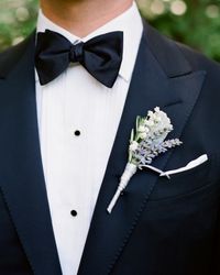 Lily of the valley, lamb's ear leaves, and lavender and rosemary sprigs adorned the groom's lapel.