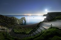 Durdle Door Moonlight - Durdle Door steps and the moon setting over Bats Head…