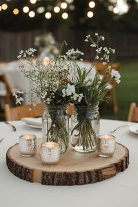 ❤️ Save for later 👉 Tap to see all 25 Affordable Wedding Centerpieces ❤️ Rustic Mason Jar Wedding Centerpiece. Simple and chic, this mason jar wedding centerpiece on a rustic log slice is ideal for an outdoor or barn wedding, adding a touch of vintage charm with a modern twist.