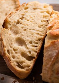 Close up showing large holes in slice of artisan style bread made from scratch