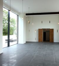 These slim #slidingglassdoors are over 4m tall and provide an impressive #windowdesign to this luxury barn conversion in Hampshire. The aluminium sliding doors are fully insulated with 21mm sightlines vertically. All outer framing is hidden with a floor to ceiling glass design.