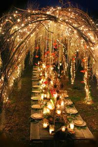 faerie party table | An enchanting evening tablescape with sparkly twinkle lights, sweeping branches, candlelight, dangling crystals and floating butterflies