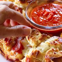 This Pizza Monkey Bread is the perfect party appetizer with pepperoni, cheese, and marinara sauce.