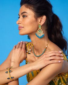 Timeless and elegant, our Aurelia Bangle evokes treasures of Troy. Regal yet discreet, it may be worn to adorn a sun dress (like our Flora Dress), statement gown (like our Electra One Shoulder Dress) or a casual poncho (like our Marbella Poncho).• Flexible frame• Slip on with opening• Gold plated • Blue colored faceted glass• Hand-crafted • Height: 1.625" • 1.1 oz • Zinc free • Made in India SHOP ALL JEWELRY Item #3WJRY-JN-204 Flora Dress, Blue Plates, Faceted Glass, Gift Bag, One Shoulder Dress, Hand Crafted, One Shoulder, Gold Plate, Bangles