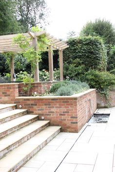 an outdoor patio area with steps and plants