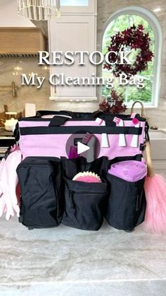 a black and pink bag filled with lots of cleaning supplies sitting on top of a counter