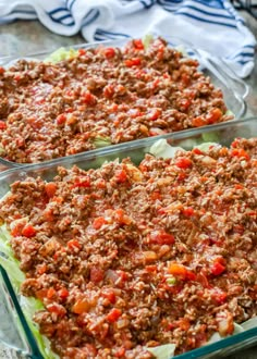 two glass casserole dishes filled with meat and vegetables on top of a table