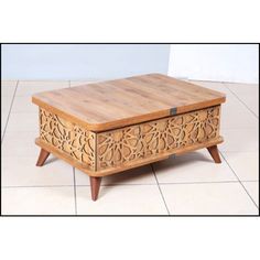 a wooden box sitting on top of a tiled floor