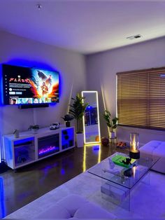 a living room filled with furniture and a flat screen tv mounted to the side of a wall