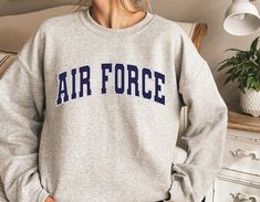 ✈🛫Air Force Unisex Sweatshirt or Hoodie, Air Force College style Sweatshirt, Air Force Army Sweater, Vintage Crewneck, Gift for Air Force Unisex Crew Neck Sweatshirt | Gildan 18000 This well-loved Unisex Crew Neck Sweatshirt is the perfect addition to any collection! The air-jet spun yarn and quarter-turned fabric helps eliminate creases and piling, while the mix of cotton and polyester creates a soft and comfortable feel. 50% cotton, 50% polyester. Unisex Heavy Blend Hoodie | Gildan 18500 With Air Force Sweatshirt, Air Cadets, Air Force Hoodie, Air Force Army, Air Force Gifts, Air Force Shirt, Wishlist 2024, Hoodie Aesthetic, Coffee Sweatshirt