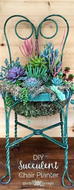 succulent planter on an iron stand with moss and flowers in it, sitting on a wooden floor