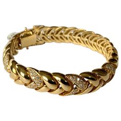 By Swiss designer Gübelin, this 18 K yellow Gold bracelet with a classic and timeless design is set with 182 brilliant cut Diamonds weighing approximately 2 ct, G color, vs clarity. The length is 19 cm the width is 1.2 cm and the bracelet weighs 63.17 grams. This is a great bracelet for everyday wear. Masterfully handcrafted piece! Authenticity and money back is guaranteed. For any enquires, please contact the seller through the message center. Luxury Yellow Gold Symbolic Bracelets, Luxury 22k Gold Yellow Bracelet, Luxury Yellow Gold Bracelet With Intricate Design, Luxury Vintage Gold Bracelet As A Gift, Luxury Yellow Gold Engagement Bangle, Luxury Yellow Gold Jewelry For Formal Occasions, Luxury Yellow Gold Ornate Bracelet, Luxury Vintage Gold Bracelets, Luxury 22k Gold Symbolic Jewelry