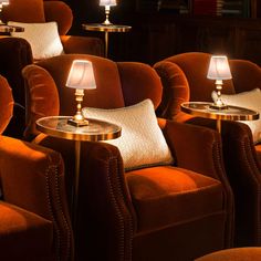 rows of chairs with lamps on them in a room