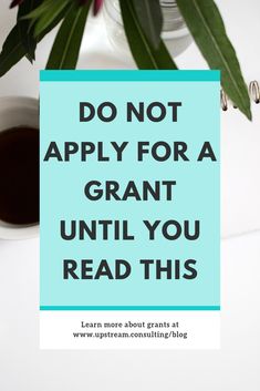 a blue sign that says do not apply for a grant until you read this