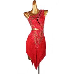 a red dress on a mannequin with gold sequins and fringe detailing