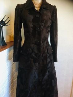 A gorgeous vintage coat dress in dark brown by Hardy Amies Boutique. This beautifully tailored coat dress features slight puff long sleeves with cuff and buttons, single breasted open front with matching plastic buttons and a hook, two large pockets with flaps and button detail, two pleats at the back and full lining. The main fabric has a texture to it like faux fur.  A fabulous 50's-60's coat dress to define its era.   **In 1945, Sir Hardy Amies was already a well-known designer of Women's hou Brown Winter Evening Outerwear, Brown Long Sleeve Evening Outerwear, Brown Long-sleeved Outerwear For Evening, Brown Long Sleeve Outerwear For Evening, Brown Fitted Long Fur Coat, Winter Dress Coat, 60s Coat, Winter Coat Dress, Hardy Amies