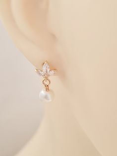 a close up of a pair of earrings on a mannequin