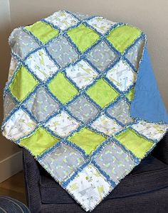 a blue and green blanket sitting on top of a chair