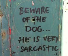 graffiti on the side of a building saying beware of the dog he is very sarcastic