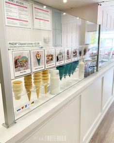 an ice cream shop display case filled with lots of different types of ice creams