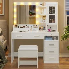 a white vanity with lights on it in a bedroom