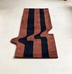 an orange and black rug on the floor