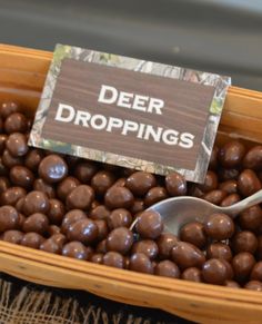 a basket filled with chocolate candies and a sign that says deer droppings on it