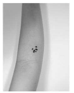 a black and white photo of a person's arm with a smiley face on it