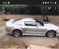 a silver sports car parked on the side of a road