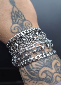 Layered Multi-Strand Steel Bracelet - This punk style or alt goth statement bracelet makes a great gift for her. All stainless steel so this bracelet will NOT tarnish. Completely water proof.  Chains may differ slightly based on stock, but will be same quality, size, and style. ⚡Sizing to help you choose the most accurate size of bracelet. ⚡ Step 1:   Measure your wrist (where you often wear your bracelets) with a tape measure or a long strip of paper, and get your wrist circumference. Step 2:   For a  snug fit, add a 1/2 inch. For a comfort fit, add 1 inch. ⭐RECOMMENDED SIZES:⭐ 7 inch: Extra small frame biological female 7.5 inch: Small frame biological female 8 inch: Medium frame biological female, small frame biological male 8.5 inch: Large frame biological female, medium frame biologic Punk Style Bracelets With Studs, Metalhead Bracelets, Punk Stainless Steel Jewelry For Party, Punk Style Stainless Steel Jewelry For Party, Punk Style Stainless Steel Party Jewelry, Edgy Jewelry Bracelet Strap As Gift, Edgy Bracelet Strap Jewelry Gift, Edgy Jewelry Bracelet Strap Gift, Edgy Jewelry With Bracelet Strap For Gift