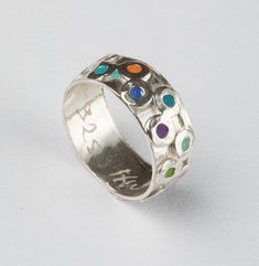 Sterling Silver band handmade with silver circles with colorful rainbow filling, Pink red green turquoise yellow orange, finished with resin. An original design with beautiful detailing. H.W signature inside the ring plus 925 sign for Sterling silver Size: 6-7-8-9 available. Please tell me what your size is in the message to the seller as you check out. Feel free to contact me for a different size. The ring will arrive in a gift box and ready to give as a gift. I accept payment via Pay-Pal only. Unique Multicolor Multi-stone Rings, Adjustable Multicolor Enamel Round Ring, Artisan Multicolor Turquoise Ring, Handmade Multicolor Turquoise Ring In Sterling Silver, Handmade Multicolor Turquoise Sterling Silver Ring, Multicolor Multi-stone Turquoise Ring Gift, Unique Multicolor Sterling Silver Turquoise Ring, Unique Multicolor Turquoise Ring In Sterling Silver, Multicolor Turquoise Ring In Sterling Silver