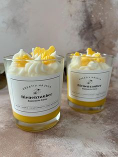 two candles with yellow and white decorations on them